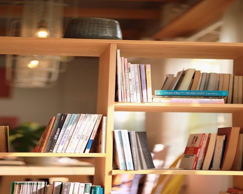 Persona leyendo un libro junto a una ventana con luz natural filtrada